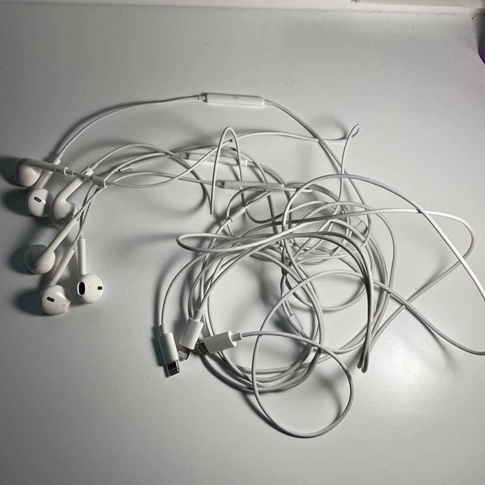 Three Apple headphones